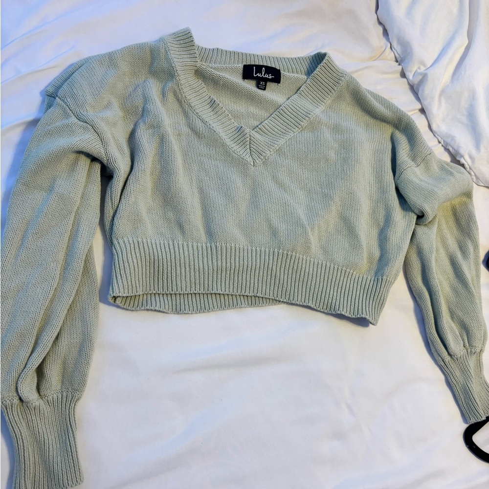 Light green sweater. Size small, V lined around the neck.